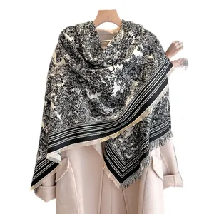 Classic black and white forest print shawl with fringe details on a wool coat