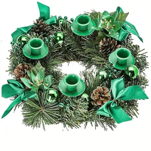 Detailed view of green Christmas wreath with pine cones, bows, and four candle holders
