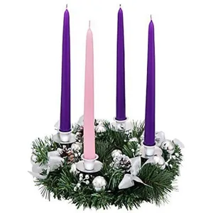 Christmas Advent wreath with three purple and one pink candle with silver ornaments