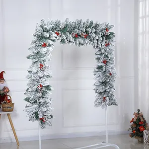 2.7m flocked Christmas garland with snow effect, pine cones and red berries on white arch stand