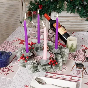 Christmas Advent wreath with purple and pink candles, pine cones and snow-tipped needles