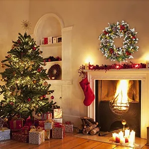 Cozy festive setting showing a Christmas wreath with pine cones and red berries on a mantel