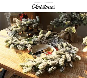 Detailed view of snowy PE pine needle garland for winter Christmas interior decoration