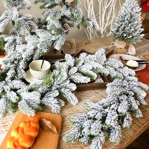 Artificial flocked Christmas garland with realistic snow and natural pinecones for decor