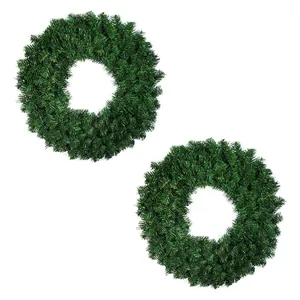 Detail of two classic green PVC artificial pine wreaths for Christmas door decoration
