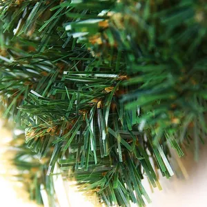 Macro detail of dense PVC artificial pine needles with brown accents for Christmas wreaths