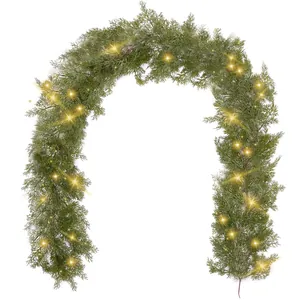 Artificial Christmas garland with warm LED lights and green PE pine needles on white background
