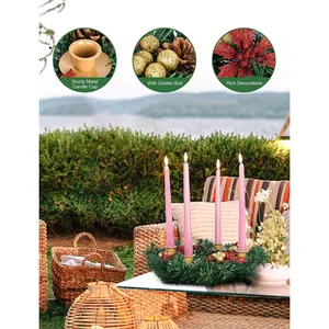 Christmas wreath candle holder with red flowers, pine cones and four pink candles