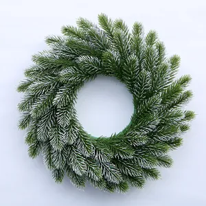Macro shot of 35cm frosted evergreen wreath with detailed snow-tipped needles decoration