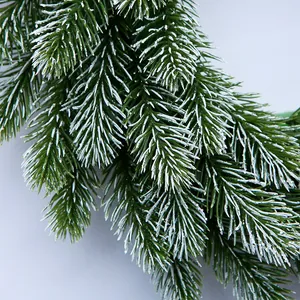 Close-up of 35cm artificial pine needles with white frost finish for Christmas decor