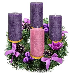 Christmas advent wreath with four pillar candles, pine needles and purple ornaments