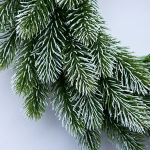 Detailed view of 35cm pine needle Christmas wreath with dense green leaves and white snow flocking