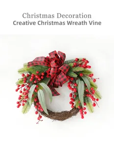 Macro detail of Christmas wreath with red berries, pine needles and a buffalo plaid bow