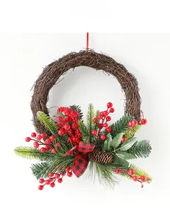 Close-up of rustic Christmas wreath featuring red berries, pine needles, and a plaid bow