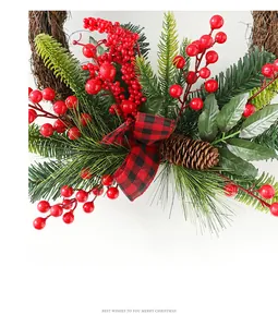 Detail of Christmas wreath with red berries, pine cones and red-black checkered ribbon
