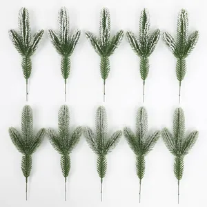 Detail of ten snow-dusted green pine needle branches for festive Christmas DIY decoration