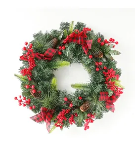 Detail showing artificial pine branches with red berries and pine cones for Christmas decor