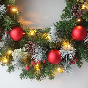Christmas wreath with LED lights, pine cones, red berries and festive ornaments