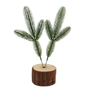 Detail showing artificial snowy pine needles set in a natural round wooden base