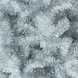 Dense silver artificial Christmas tree branches with shimmering metallic needles and texture