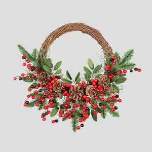 Christmas wreath with pine cones and red berries on a rustic rattan base for door decor