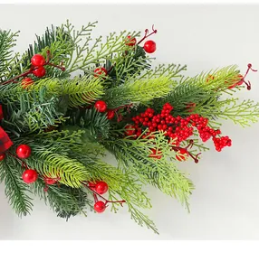 Detail of green pine needles and red berries for Christmas wreath door decoration
