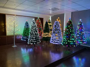 Variety of glowing LED artificial Christmas trees with colorful lighting and snowflake tips