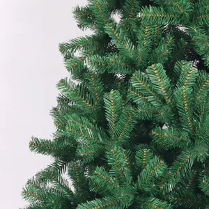 Close-up of dense green PVC pine needles and realistic branch texture on the Xmas tree