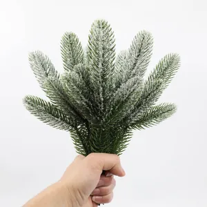 Close-up of frosted three-prong pine needle branch with realistic artificial snow detail