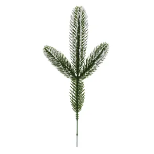 Detailed view of artificial snowy pine needles with three-forked festive winter branch