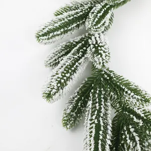 Close-up of artificial snow-covered pine needles for Christmas winter decorations