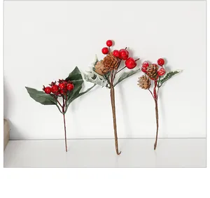 Detailed view of artificial Christmas picks with red berries, pine cones and green leaves