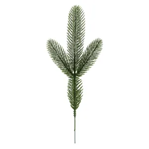 Close-up of artificial frosted pine branch with three forks and white snowy needles