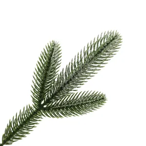 Close-up of frosted artificial pine branch with realistic snow texture for holiday decor