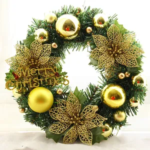 Detail of Christmas wreath with golden balls, hollow flowers and Merry Christmas sign