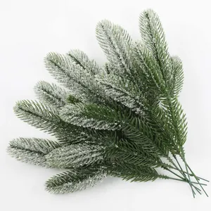 Close-up of artificial pine needles with white snowy flocking for Christmas decor