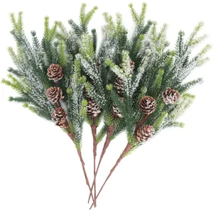 Detail of five artificial frosted pine branches with natural pine cones for Christmas decor