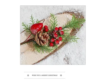 Christmas pine cone branches with red berries and needles on a snowy wood slice