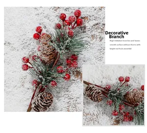 Detailed view of snowy Christmas pick with red berries and pine cones for decor