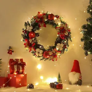 Kerstkrans met LED-verlichting, kerststerren, rode ballen en natuurlijke dennenappels