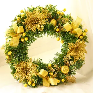 Detail of Christmas wreath featuring golden glitter flowers and berries with silk ribbons