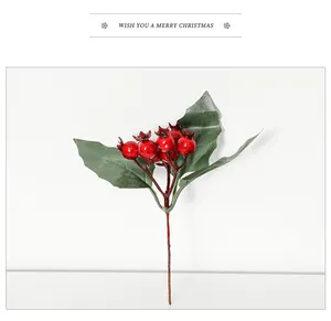 Close-up of red Christmas berry stems with glossy berries and dark green serrated leaves