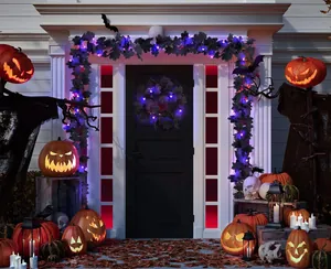 Close-up of black maple leaf garland with purple LED lights for Gothic Halloween decor