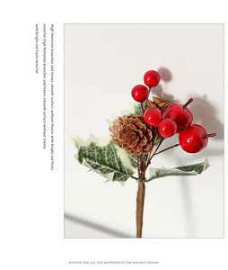 Detail of high imitation red berries with pine cones and green leaves for Christmas decor