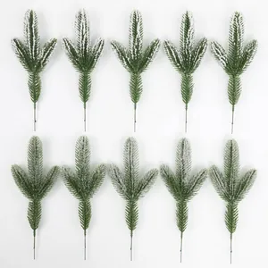 Set of 10 flocked pine needles with snowy white finish and realistic three-pronged shape