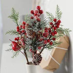 Christmas decoration pick with red berries pine needles and snow-covered pine cones