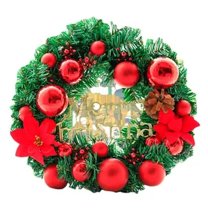 Classic Christmas wreath with red ornaments, pine cones and Merry Christmas sign