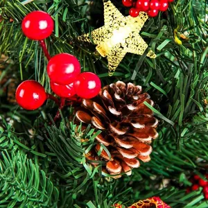 Christmas garland detail with pine cones, red berries and a sparkling gold star ornament