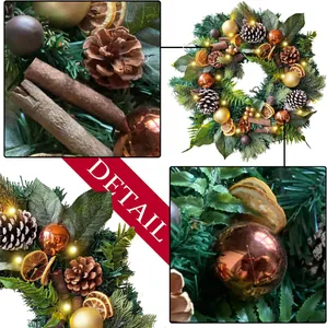 Christmas wreath with LED lights, pine cones and orange slices for festive door decoration