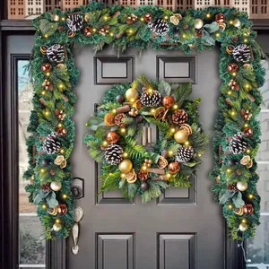 Christmas wreath and garland set with LED lights and pinecones on a dark wooden door